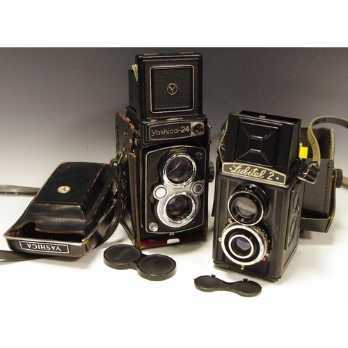 321 - A Yashica-24 twin lens reflex camera, 80mm 1:3.5 lens, original leather case; a Russian Lubitel 2 tw... 