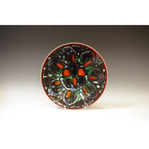 59 - A Poole Pottery Adelphis bowl, decorated with a black, burnt orange and green seven petal flower, pr... 