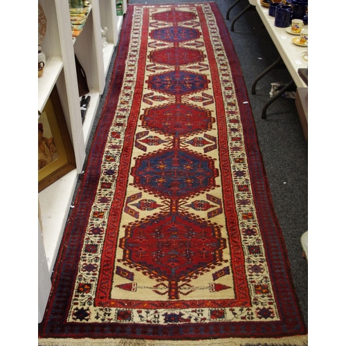 62 - A Hand Made Persian Sarab Runner, red and cobalt hexagonal design on cream ground, 453cm x 100cm.