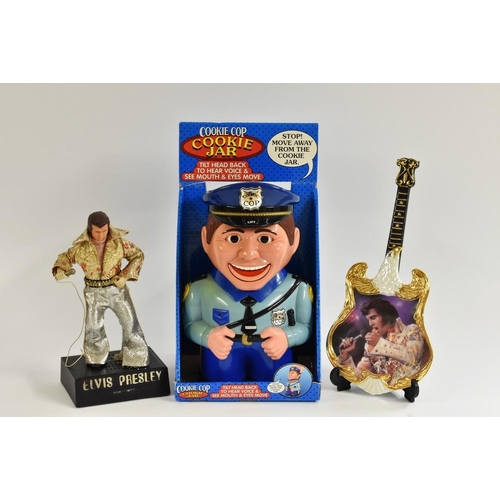 58 - A novelty Elvis Presley figural radio; an Elvis ceramic guitar, with certificate; a Cookie Cop cooki... 
