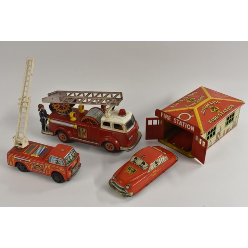 62 - Tinplate - a Marx Automatic Fire Station, with fire engine; a small fire engine with plastic ladder,... 