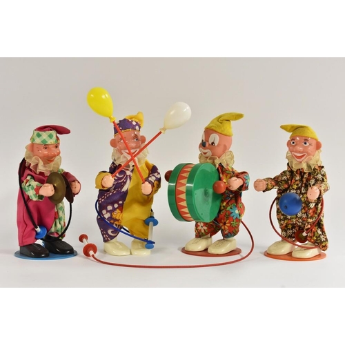 84 - A four man clown band, playing the drums, symbols and holding balloons,  three in original boxes, on... 