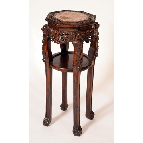 1574 - A Chinese padouk wood octagonal jardiniere stand, the top with inset soapstone panel above a circula... 