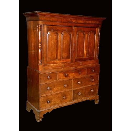 1581 - A George III Welsh oak housekeeper's press cupboard, outswept cornice above a pair of rectangular do... 