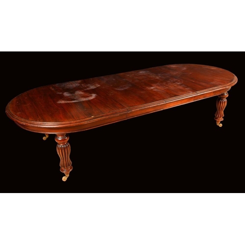 1583 - A Victorian style mahogany extending dining table, moulded elliptical top, turned and reeded inverte... 