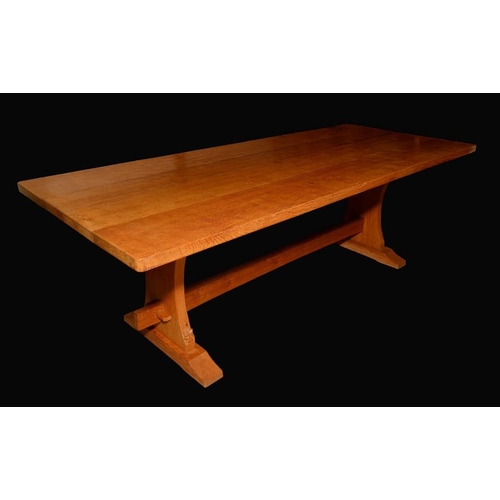 1589 - Wilf Hutchinson, Squirrelman - an oak trestle dining table, rounded rectangular top, shaped end supp... 