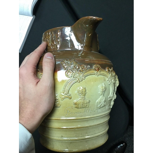 22 - A 19th century Brampton brown salt glazed pottery jug, in relief with busts of Prince Albert and Que... 