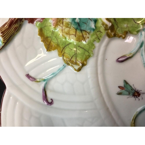 54 - A Chelsea leaf and basket weave moulded twig handled dish, painted with moths, in relief with vine, ... 