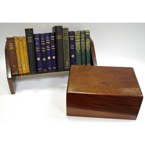 66 - An oak book trough and books including Hilaire Belloc; Charles Dickens; Thomas Hughes; a mahogany de... 