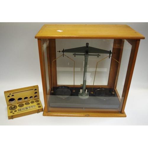 69 - A set of scientific balance scales, cased with cased weights.