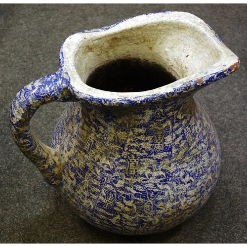 180 - A substantial jug decorated with blue and white Indonesian 'batik' pattern application