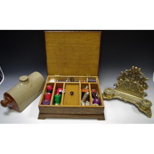 184 - An early 20th century oak sewing box holding needle, thread, thimbles, etc; an early 20th century pi... 