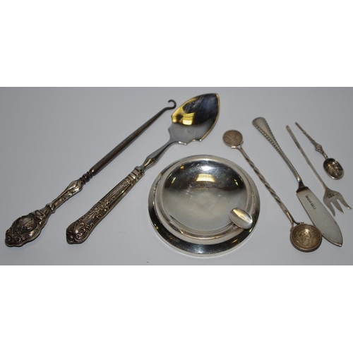 215 - Silver - a silver ashtray. pickle fork, decorative spoon, etc (7).