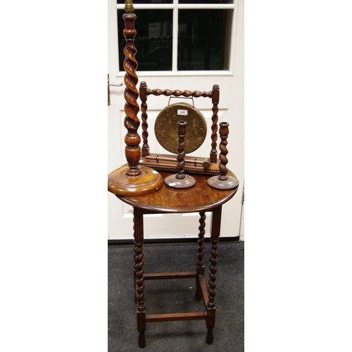 386 - A circular oak occasional table gong; candlesticks; lamp base, barley twist columns (5)