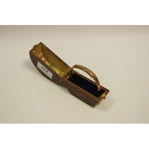 237 - An early 20th century 9ct gold hinged bangle set with a central garnet, weighs 10.5g