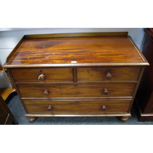 99A - A Victorian mahogany chest of two short drawers over two long turned handles and feet