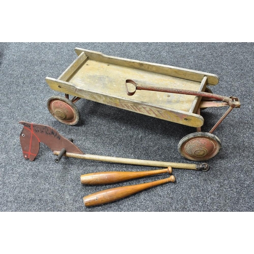 3081 - A mid 20th century child's pull-a-long cart, inscribed Air Flow,  85cm long;  a pair of jugglers bat... 