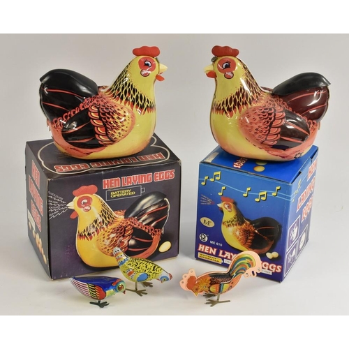 3094 - Tin plate - a retro Chinese battery operated Hen Laying Eggs model, another both with two eggs, boxe... 