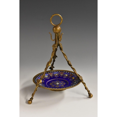 1143 - A 19th century French Limoges enamel and gilt metal tripod pocket watch stand, ring terminal above p... 