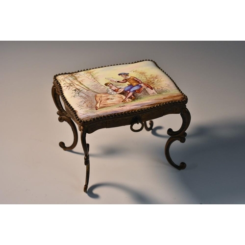 1159 - An early 20th century French enamel and gilt metal novelty miniature table, decorated with a courtin... 