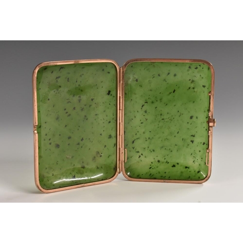 1160 - An early 20th century gold coloured metal mounted nephrite jade pocket cigarette case, hinged cover,... 