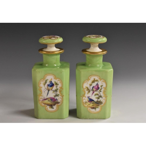 1170 - A pair of 19th century Continental porcelain canted square scent bottles, painted in colourful polyc... 