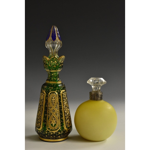 1174 - A 19th century green glass scent bottle, probably Moser, the reservoir with raised panels with scrol... 