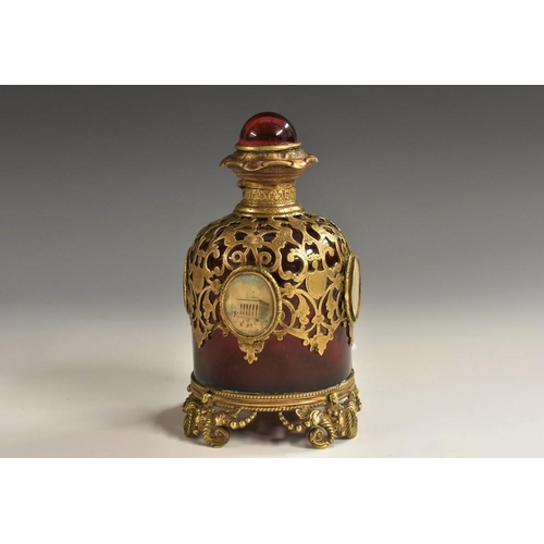 1176 - A 19th century French Palais-Royal gilt-metal mounted ruby glass scent bottle, the sides adorned wit... 