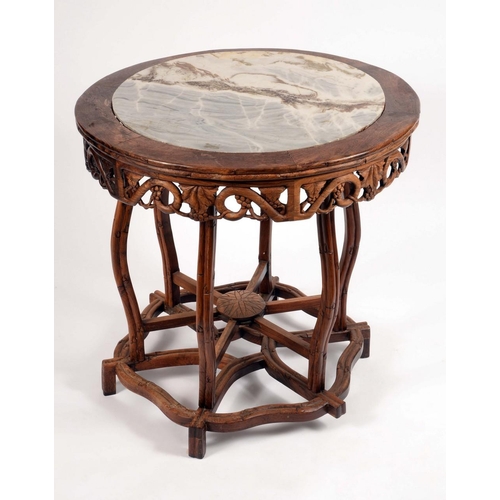 1215 - A Chinese hardwood circular centre table, dreamstone top above a shaped and pierced frieze carved wi... 