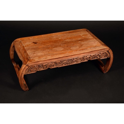 1245 - A Chinese hardwood low tea table, shaped frieze carved with scrolls and foliage centred by a seal, 2... 