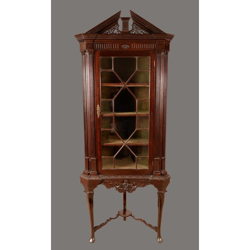 1246 - A Chippendale revival mahogany corner cabinet on stand, possibly Irish, architectural pediment above... 