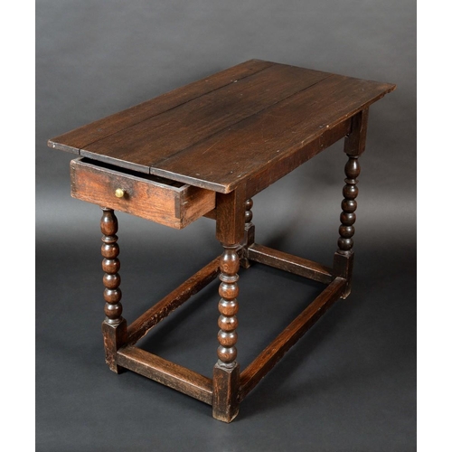 1257 - An 'early 18th century' oak occasional table, rectangular top above a frieze drawer to side, bobbin ... 