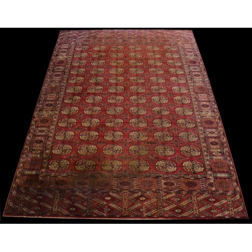 1258 - An Iranian hand knotted carpet, the garnet ground with geometric motifs of ecru and blue, label for ... 