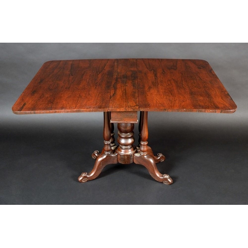 1271 - An early Victorian rosewood Sutherland table, rounded rectangular top, turned pillars, the unusual f... 