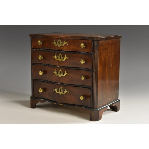 1282 - A George III mahogany serpentine miniature chest of four long graduated drawers, brass handles and p... 