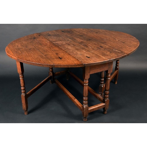 1301 - An early 18th century oak gateleg dining table, oval top, turned legs, rectangular stretchers, 75cm ... 