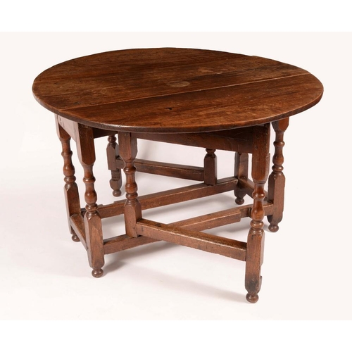 1303 - An early 18th century oak gateleg dining table, oval top, turned legs, rectangular stretchers, 75cm ... 