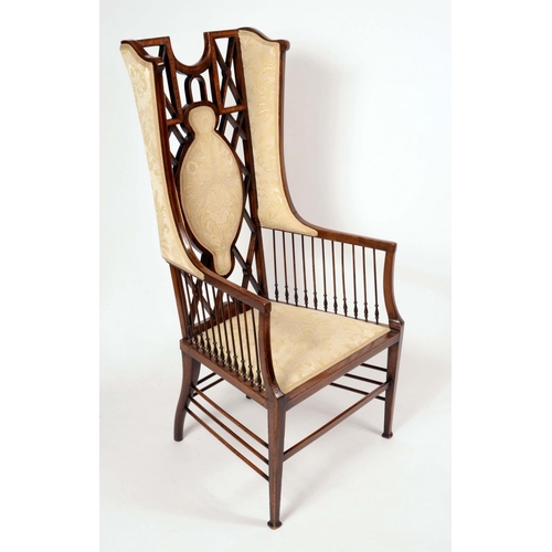 1312 - An Art Nouveau period mahogany wingback armchair, the lattice back outlined with satinwood banding, ... 