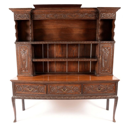 1327 - An '18th century' oak dresser, outswept cornice above an arrangement of shelves and cupboards, the p... 