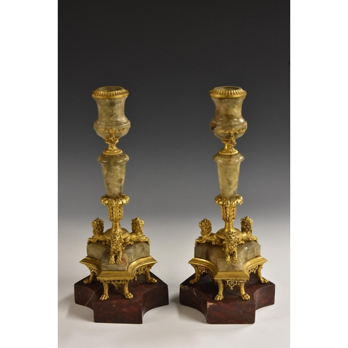 1330 - A pair of 19th century gilt metal mounted fluorspar mantel candlesticks, campana sconces, tapered pi... 