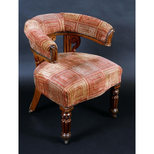 1368 - A Victorian mahogany club armchair, curved cresting rail, stuffed over upholstery, the frame carved ... 