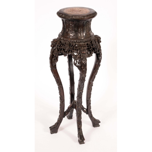 1401 - A Chinese padouk wood jardiniere stand, the spool shaped top with inset soapstone panel, cabriole le... 