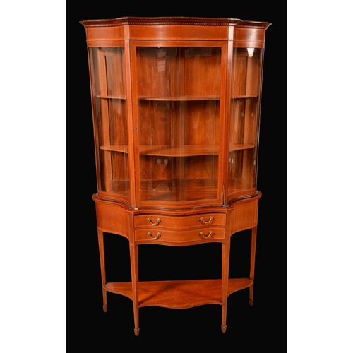 1408 - A Sheraton revival mahogany shaped serpentine salon display cabinet, outswept cornice and deep friez... 