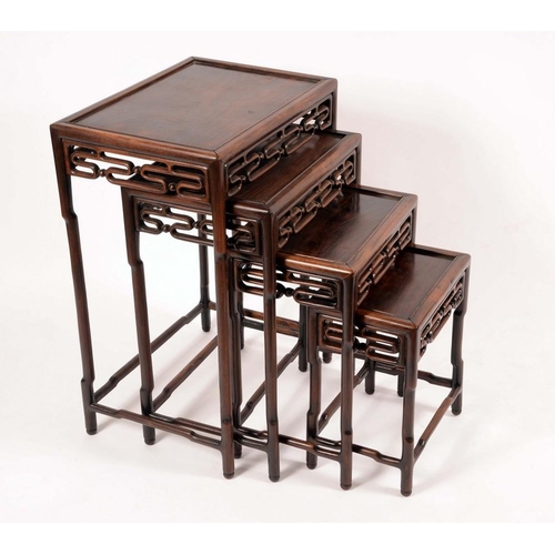 1416 - A set of Chinese padouk wood quartetto tables, each rectangular top above a pierced frieze, the larg... 