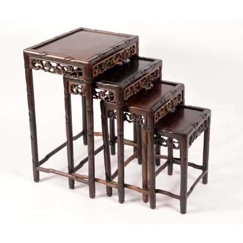 1428 - A set of Chinese hardwood quartetto tables, rectangular panel tops pierced friezes carved with birds... 