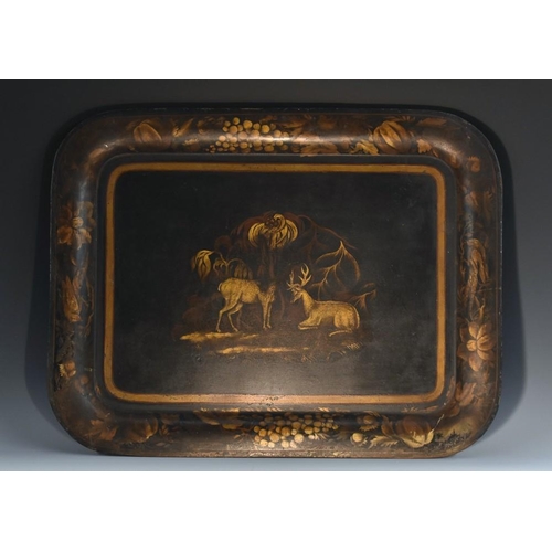 1429 - A post-Regency toleware rounded rectangular serving tray, decorated in tones of gilt with stags, wit... 