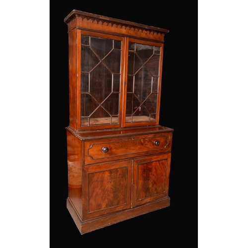 1430 - A Post-Regency mahogany secretaire bookcase, shaped cresting outlined with ebony stringing, above a ... 