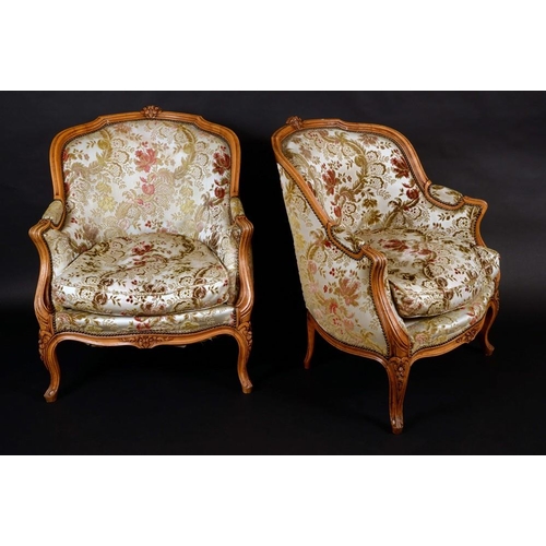 1446 - A pair of Louis XV style drawing room chairs, shaped moulded cresting rails carved with flowers, the... 