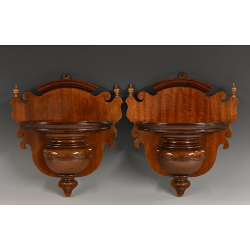 1447 - A pair of late Victorian mahogany wall brackets, shaped crestings flanked by turned finials, demi-lu... 