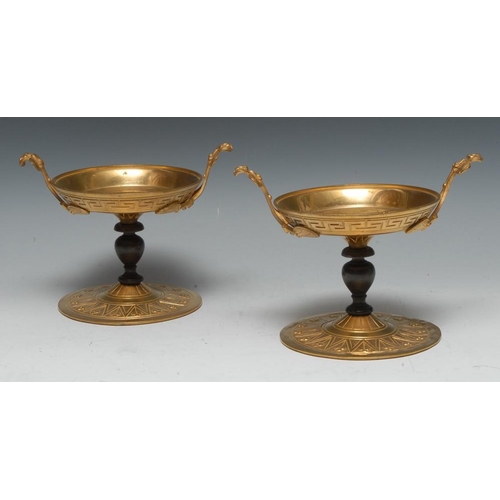 1448 - A pair of Grecian Revival dark patinated and gilt metal sweetmeat tazzas, lofty lotus handles, Greek... 